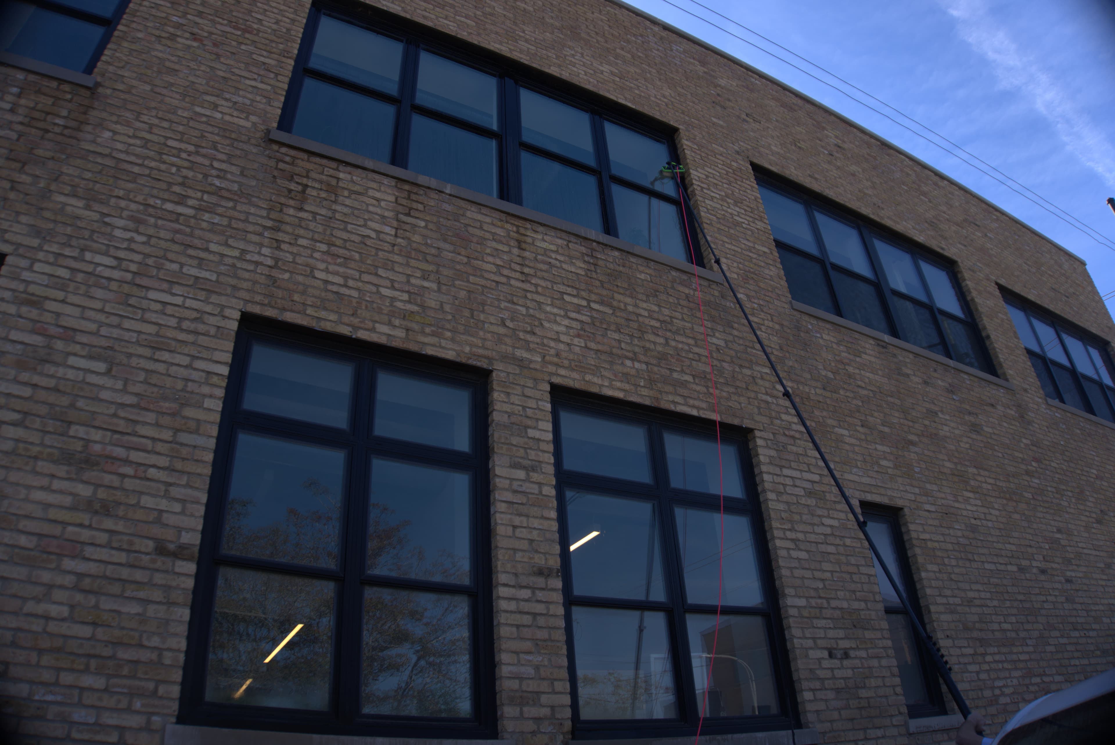 commercial brick storefront, water-fed pole reaching up