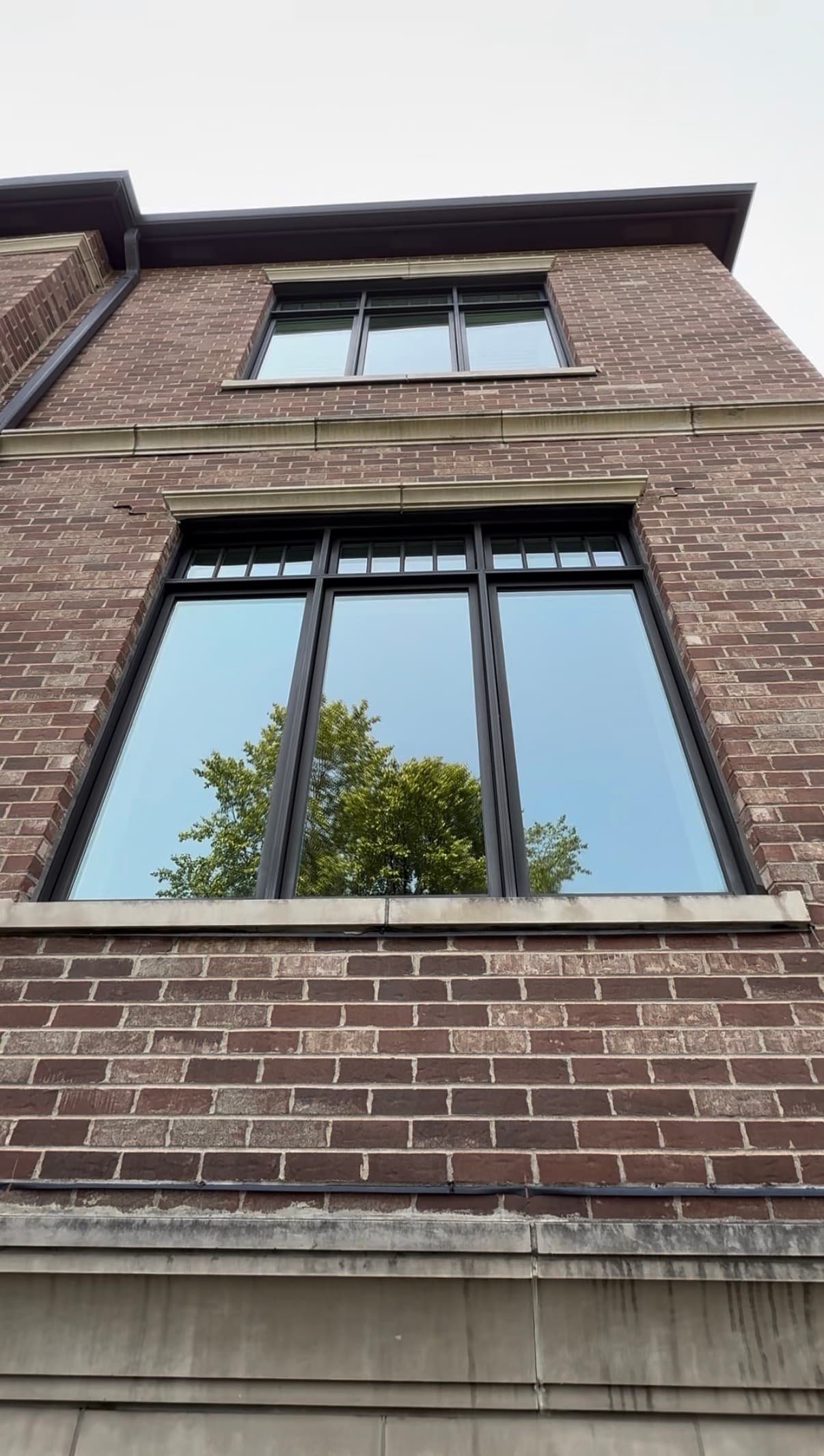 finished: tall brick three-flat, multi-pane sash windows