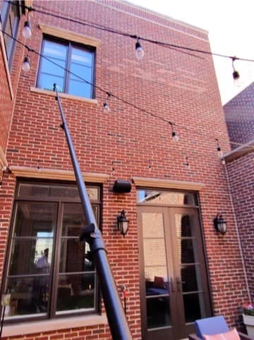 water-fed pole on a brick rowhouse
