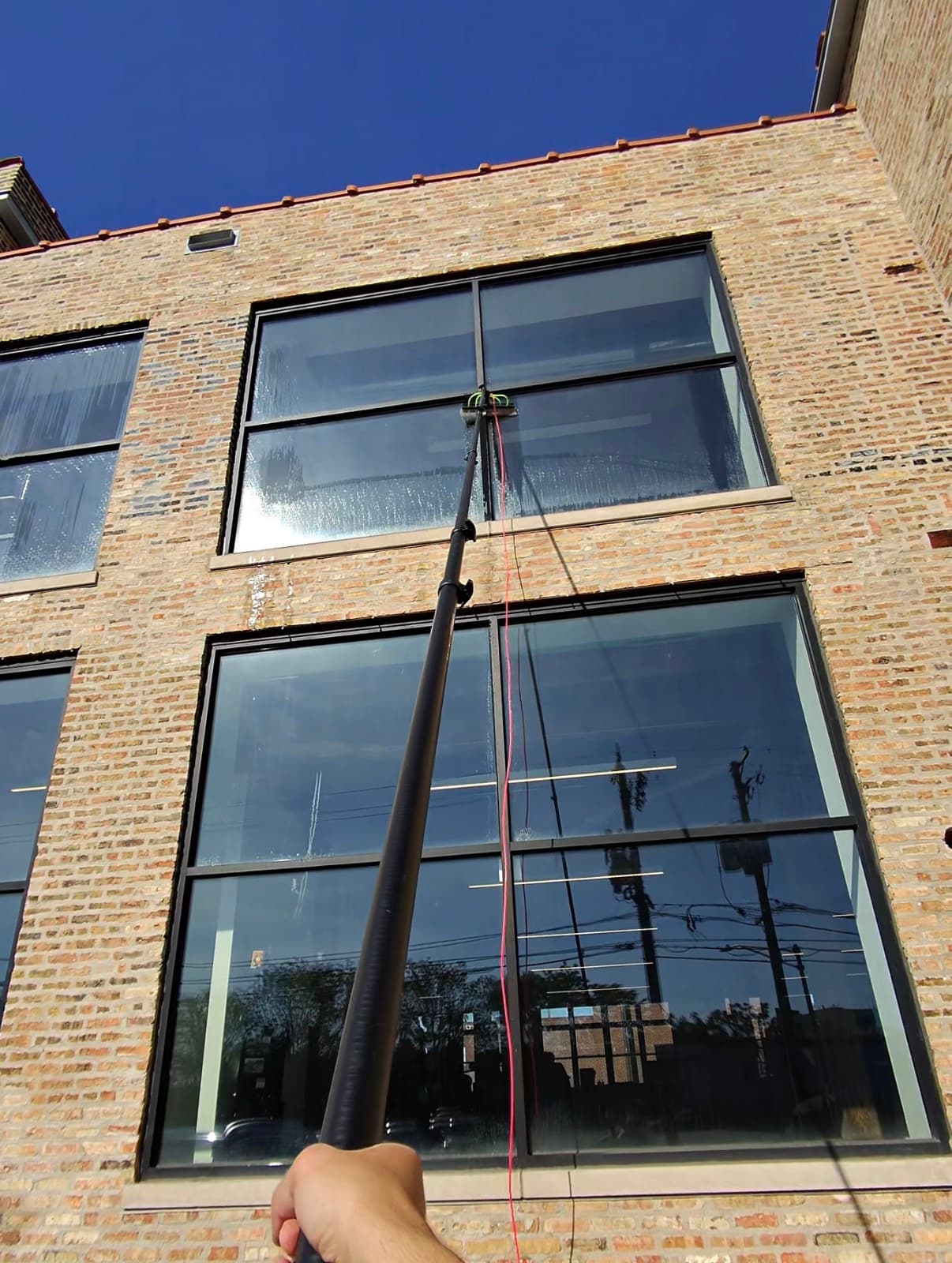 water-fed pole, commercial brick storefront — Logan Square