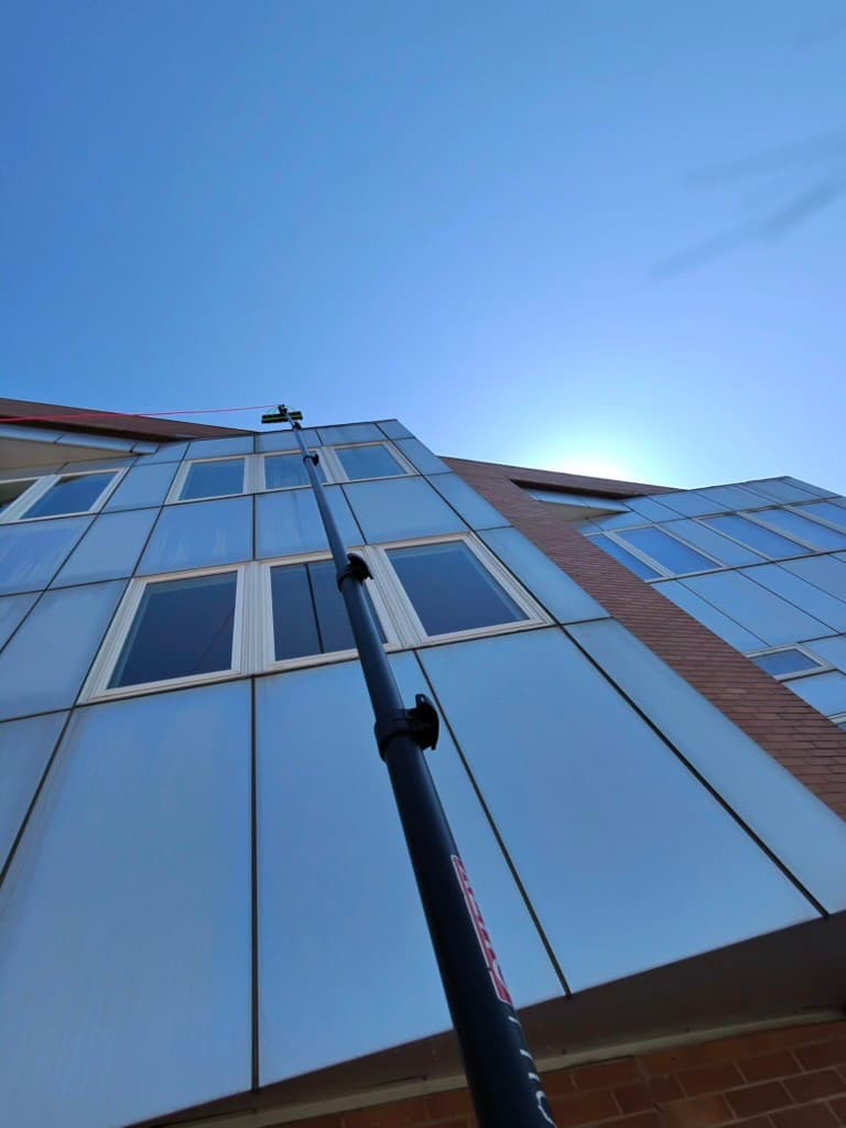 pole work up a multi-story glass facade