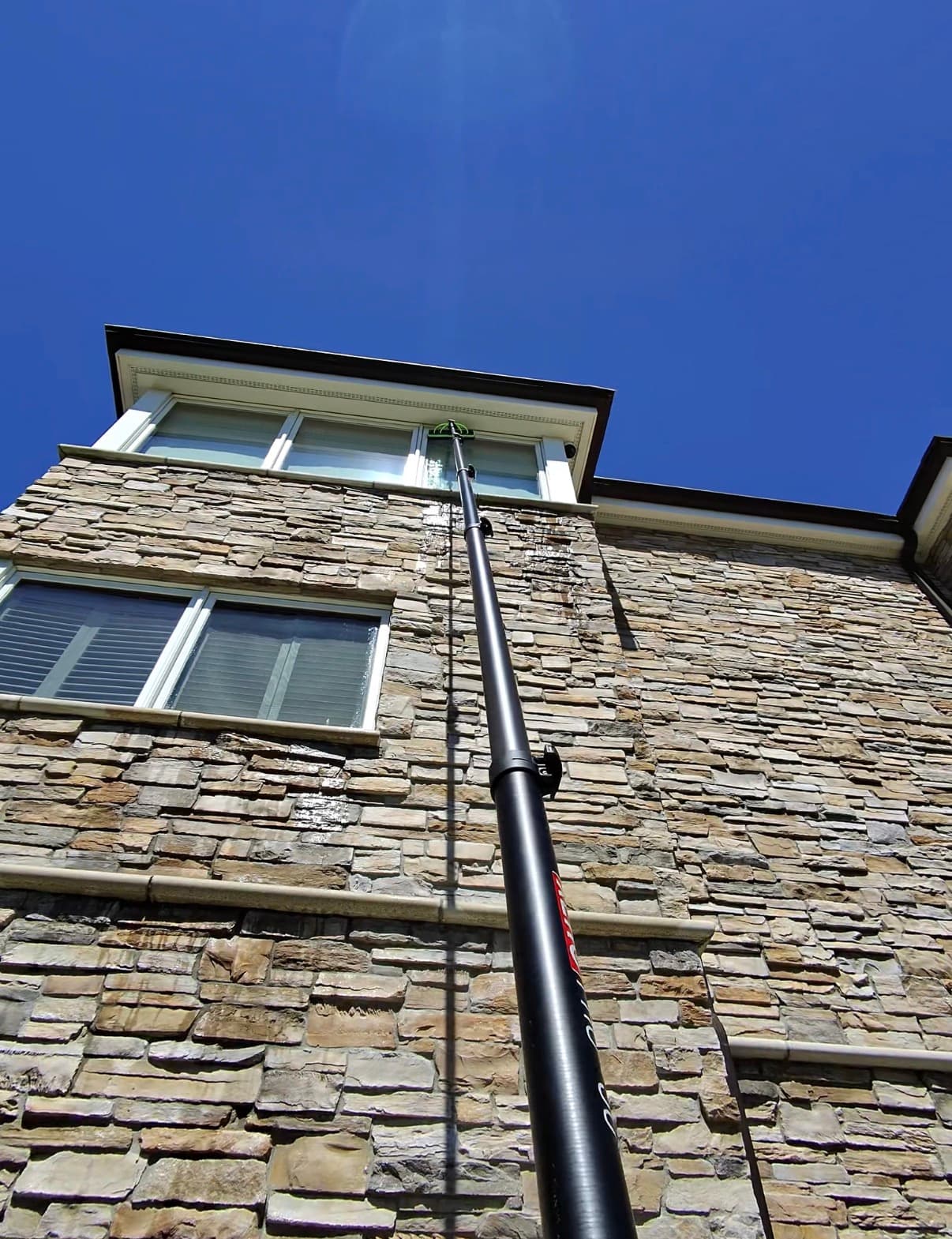 water-fed pole up a tall stone facade