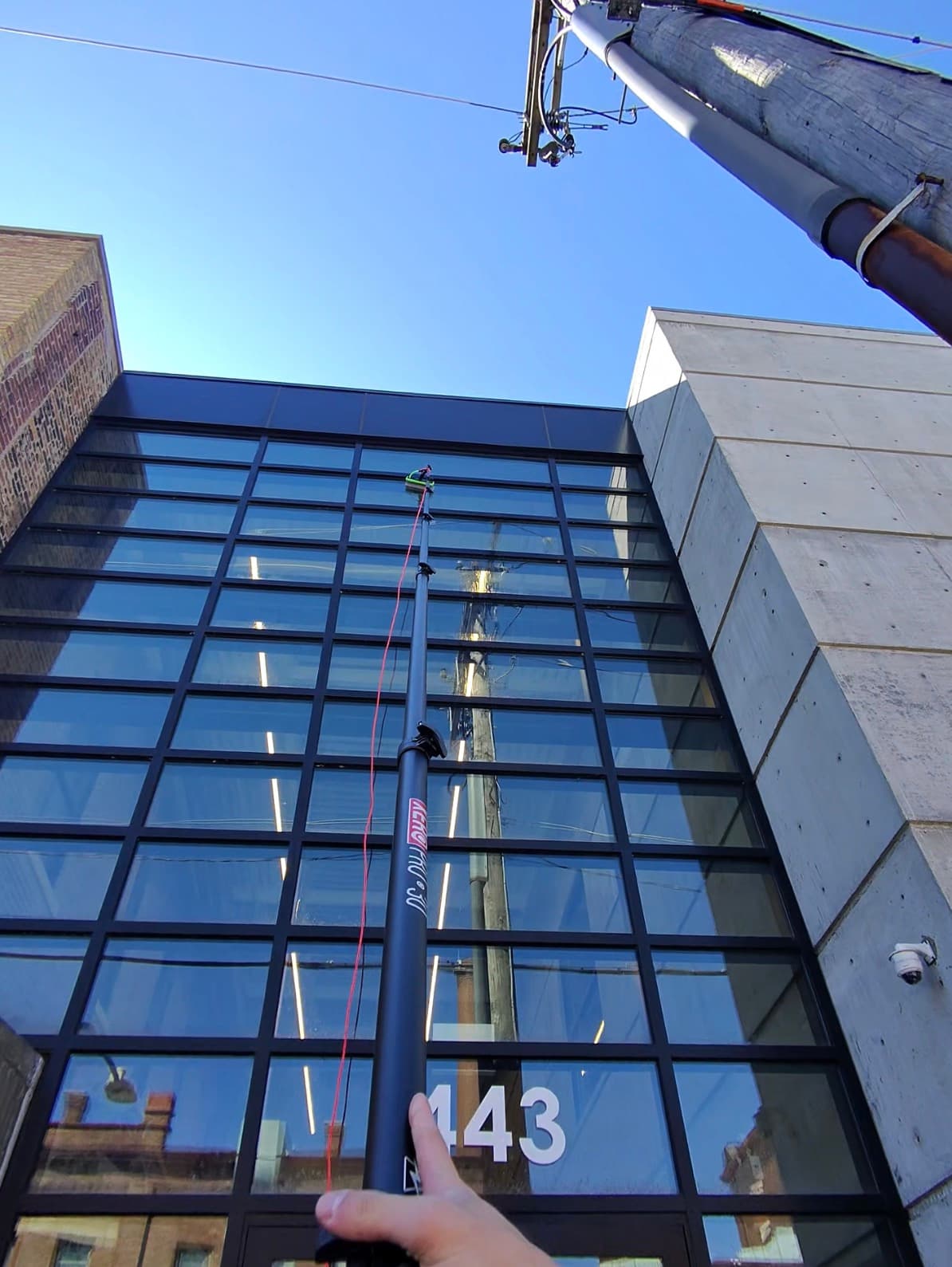 water-fed pole, four-story glass facade — West Loop