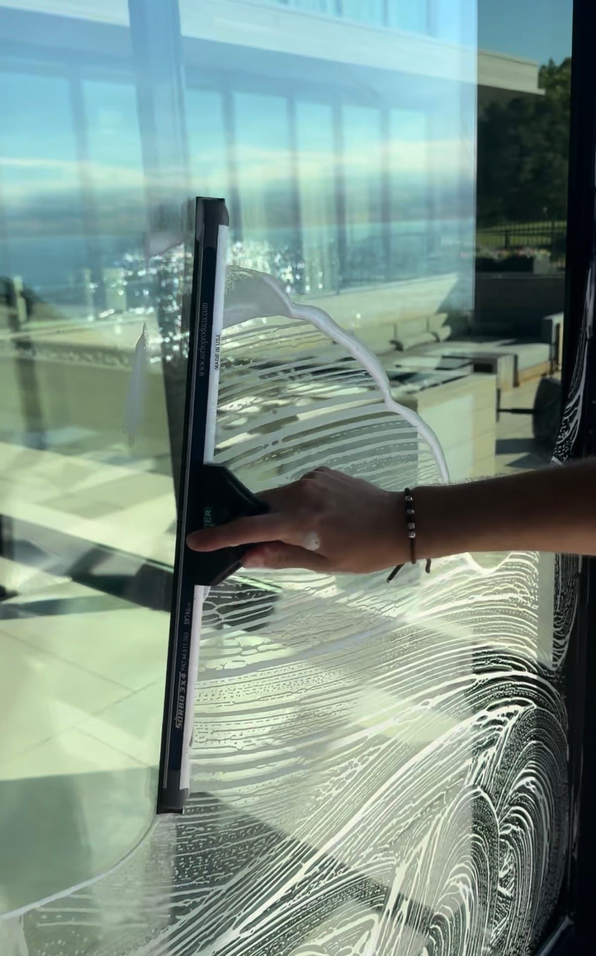 squeegee pull, soap sheeting off the glass