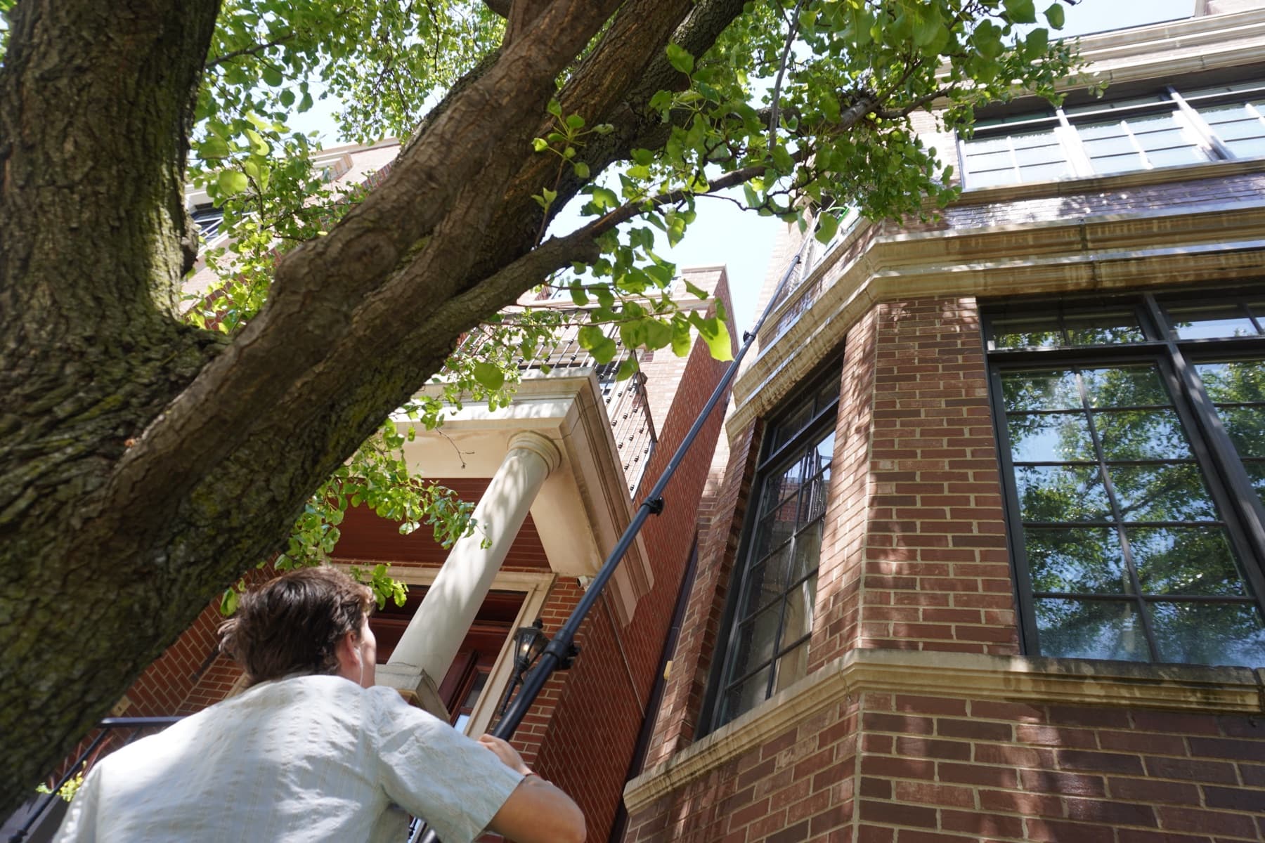 water-fed pole reaching a multi-story residential